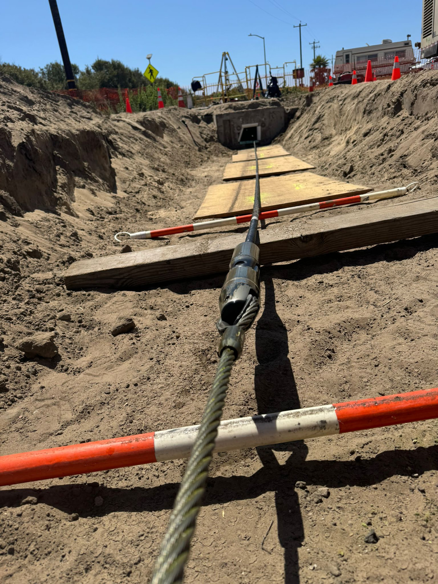 Cable pull into an underground vault along an open trench